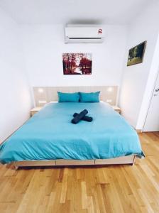 a blue bed with a black bow tie on it at Connected train 1 Bedroom (ABOVE MALL)7 in Kuala Lumpur