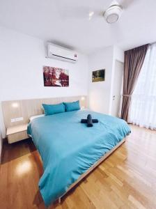 a large bed in a room with a blue blanket at Connected train 1 Bedroom (ABOVE MALL)7 in Kuala Lumpur