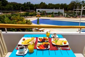 a table with plates of food on top of a pool at Santo Manglar Cartagena Life Wellness Spa Hotel in Cartagena de Indias