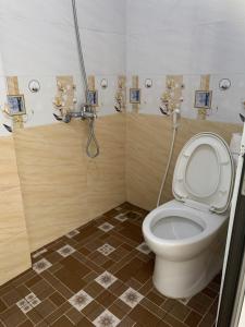 a bathroom with a toilet and a shower at Cat Ba Rustic Homestay in Cat Ba +112 photos