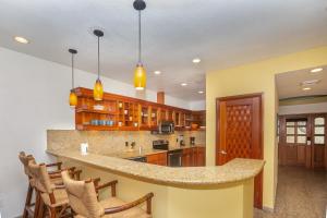 a kitchen with a large island in a room at Lawson Rock - Yellowfish 211 condo in Roatán