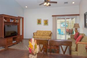 a living room with a couch and a tv at Lawson Rock - Yellowfish 211 condo in Roatan