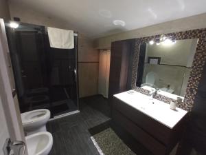 a bathroom with a toilet and a sink and a shower at Home sweet home in Calangianus +30 photos