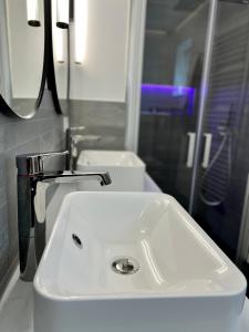 a bathroom with a white sink and two toilets at Luxus Ferienhaus Erzgebirge in Alleinlage in Kurort Altenberg