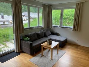 a living room with a couch and a table at Obertauern Fewo Top 12 by Kamper in Obertauern