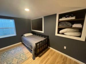 a bedroom with a bed and a large window at Quaint house in the heart of Idaho Falls in Idaho Falls