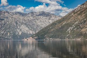 a large body of water with mountains at Blue Kotor Bay Premium Spa Resort in Kotor