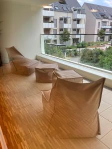 a room with brown chairs and a large window at Con4rent Business Hotel plus in Kirchheim unter Teck