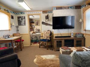 a living room with a large flat screen tv at JMA Bunkhouse in Riverton