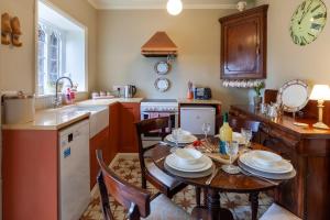a kitchen with a table and chairs and a sink at The Georgian - Norfolk Cottage Agency in East Dereham