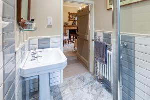 a bathroom with a sink and a shower at The Georgian - Norfolk Cottage Agency in East Dereham