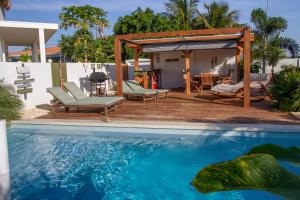 a house with a swimming pool and a gazebo at Woodz Bonaire in Kralendijk