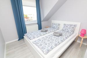 Postel nebo postele na pokoji v ubytování Apartamenty 4YOU Hel