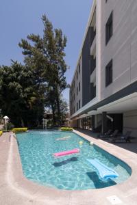 a swimming pool next to a building at Hotel Ronda Minerva in Guadalajara