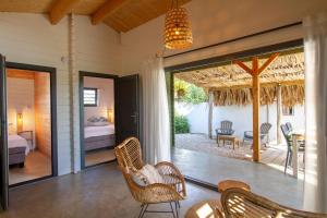 a room with a patio with a bed and a table at Woodz Bonaire in Kralendijk