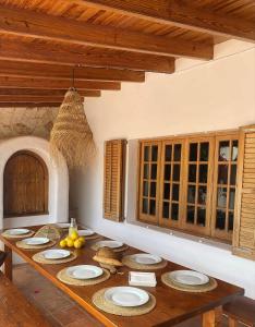 a kitchen with a wooden table with plates on it at Authentic Villa with amazing pool in Santa Gertrudis de Fruitera