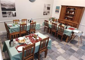a restaurant with tables and chairs with food on them at Sur La Route Des Châteaux in Thenay