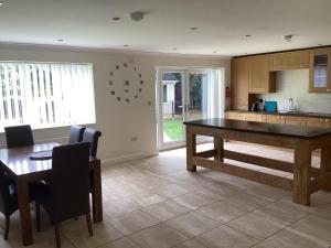 a kitchen with a table and a dining room at The hideaway in Stockton-on-Tees