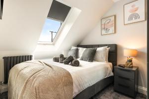 a bedroom with a large bed and a window at Hawthorn Cottage in Tenby +18 photos