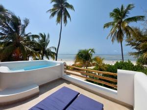 a view of the beach from the balcony of a villa at Kijani Beach Villas in Bwejuu