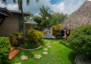 a garden with large rocks in front of a house at Portoazul Casa de Playa in Puerto Colombia