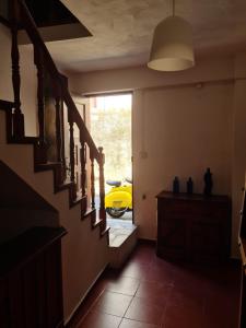 a hallway with a yellow car in the window at Casa da Portela in Penacova