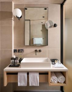 a bathroom with a sink and a mirror at Hotel Ambasador in Split
