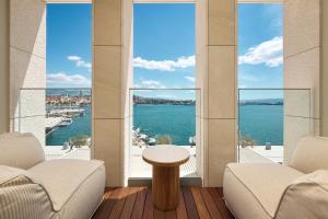 a living room with a view of the water at Hotel Ambasador in Split