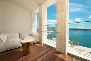 a living room with a view of the water at Hotel Ambasador in Split
