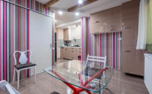 a glass table and a chair in a kitchen at Art-Gallery Avlabari in Tbilisi City