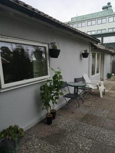d'une terrasse avec une table, des chaises et une fenêtre. dans l'établissement Minilägenhet, à Göteborg