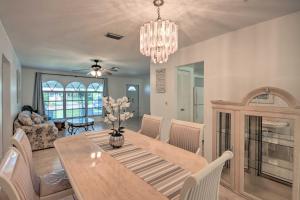 a dining room with a table and a chandelier at Port Charlotte Retreat about 4 Mi to Beach Park! in Port Charlotte