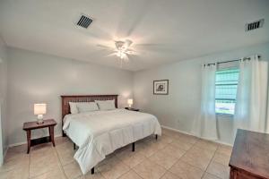 a bedroom with a bed and a ceiling fan at Port Charlotte Retreat about 4 Mi to Beach Park! in Port Charlotte
