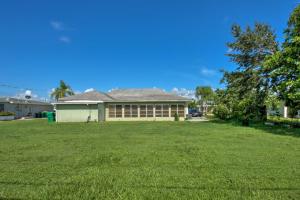 a house with a large lawn in front of it at Port Charlotte Retreat about 4 Mi to Beach Park! in Port Charlotte