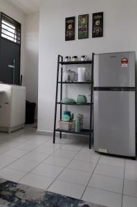 a kitchen with a white tiled floor with a refrigerator at IRIS 55 Corner Lot House Spacious Outdoor With Wi-Fi in Johor Bahru