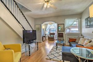 a living room with a couch and a tv at South Philly Townhome 3 Mi to Center City in Philadelphia