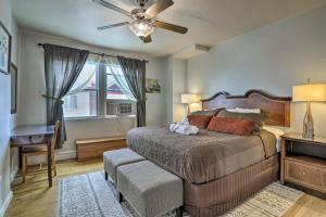 a bedroom with a bed with a ceiling fan and a desk at South Philly Townhome 3 Mi to Center City in Philadelphia