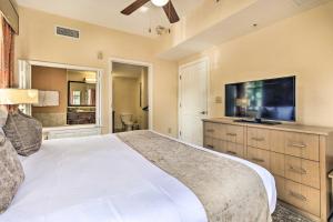 a bedroom with a large bed and a flat screen tv at Floridays Resort Condo Less Than 4 Mi to Walt Disney! in Orlando