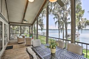 a screened in porch with a table and chairs at All Decked Out Home on Cherry Lake with Dock! in Madison
