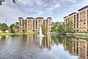 a fountain in a pond in front of a building at Floridays Resort Condo Less Than 4 Mi to Walt Disney! in Orlando
