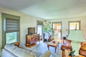 a living room with a couch and a tv at Walk to Dtwn Historic Gem with Deck in Rapid City in Rapid City