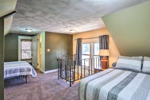 a bedroom with two beds and a window at Walk to Dtwn Historic Gem with Deck in Rapid City in Rapid City