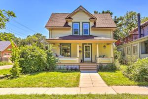 a yellow house with blue windows at Walk to Dtwn Historic Gem with Deck in Rapid City in Rapid City