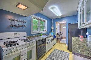 a kitchen with blue walls and a stove top oven at St Croix Falls Remote Retreat Pet Friendly! in Saint Croix Falls