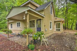 a small yellow house with a purple door at St Croix Falls Remote Retreat Pet Friendly! in Saint Croix Falls