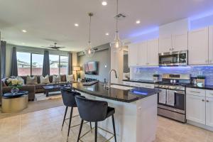 a kitchen with white cabinets and a living room at Resort Pool and Hot Tub 55 and Indio Desert Oasis in Indio