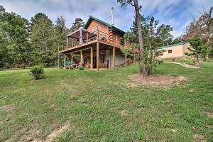 a house on a hill with a tree at Rural Wooded Cabin Near Trophy Trout Fishing! in Norfork