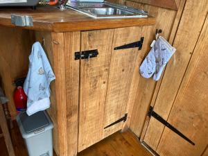 a kitchen with wooden cabinets and a sink at Berwyn Shepherds Hut in Wrexham