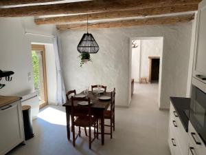 a kitchen and dining room with a table and chairs at Le Lodge du Lac in Talloires +14 photos