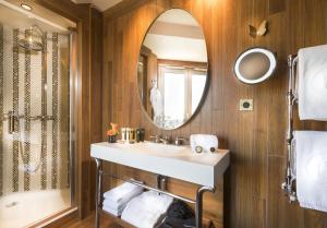 a bathroom with a sink and a mirror at Hotel Maison FL in Paris